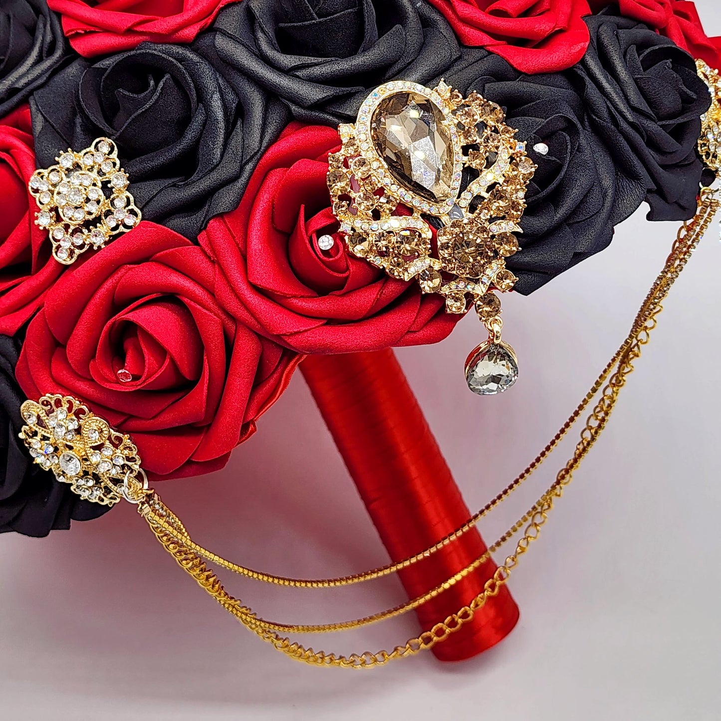 Red and Black Bridal Bouquet With Cascading Gold Chains and Brooches