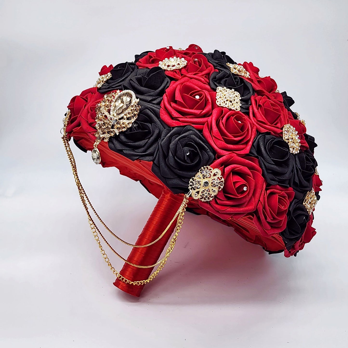 Red and Black Bridal Bouquet With Cascading Gold Chains and Brooches