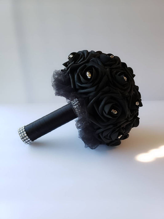 Gothic black skull bouquet with real touch roses, silver skulls, handle made using black tulle and satin ribbon and finished with silver bling wrap. 