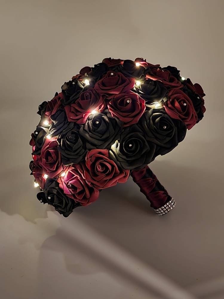 Burgundy and black fairy light bridal bouquet with burgundy and black satin ribbon handle. 