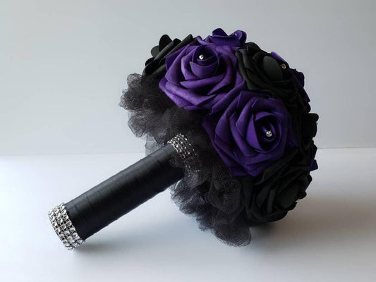 Dark Purple and Black Wedding Bouquet Made with Real touch roses. Flowers have a rhinestone on every rose. Handle is made out of black tulle and black satin ribbon and finished with silver bling wrap. 