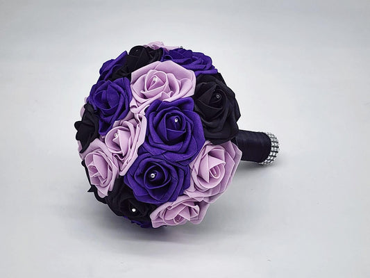 Modern Purple and Black Bridal Bouquet made with real touch roses. Rhinestones are in the center of every rose. Handle is made up of black satin ribbon and finished with silver bling wrap. 