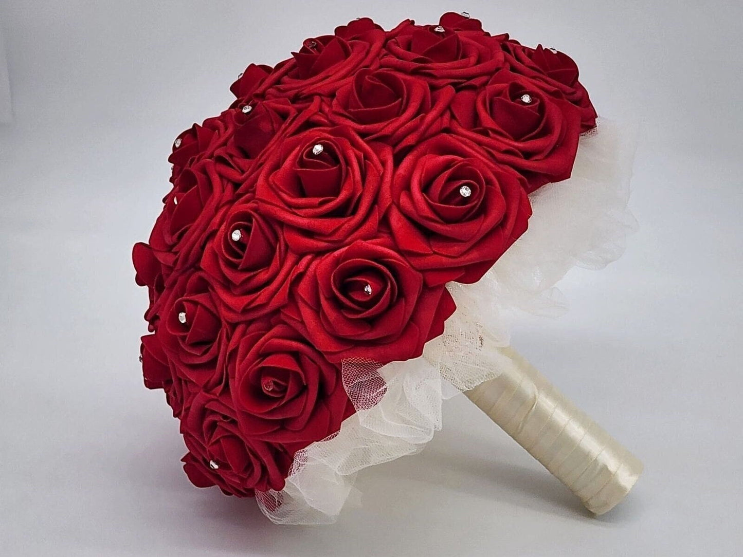 Red and Ivory Wedding Bouquet made with real touch roses. Rhinestones placed on every rose. Handle is made up of ivory tulle, ribbon.