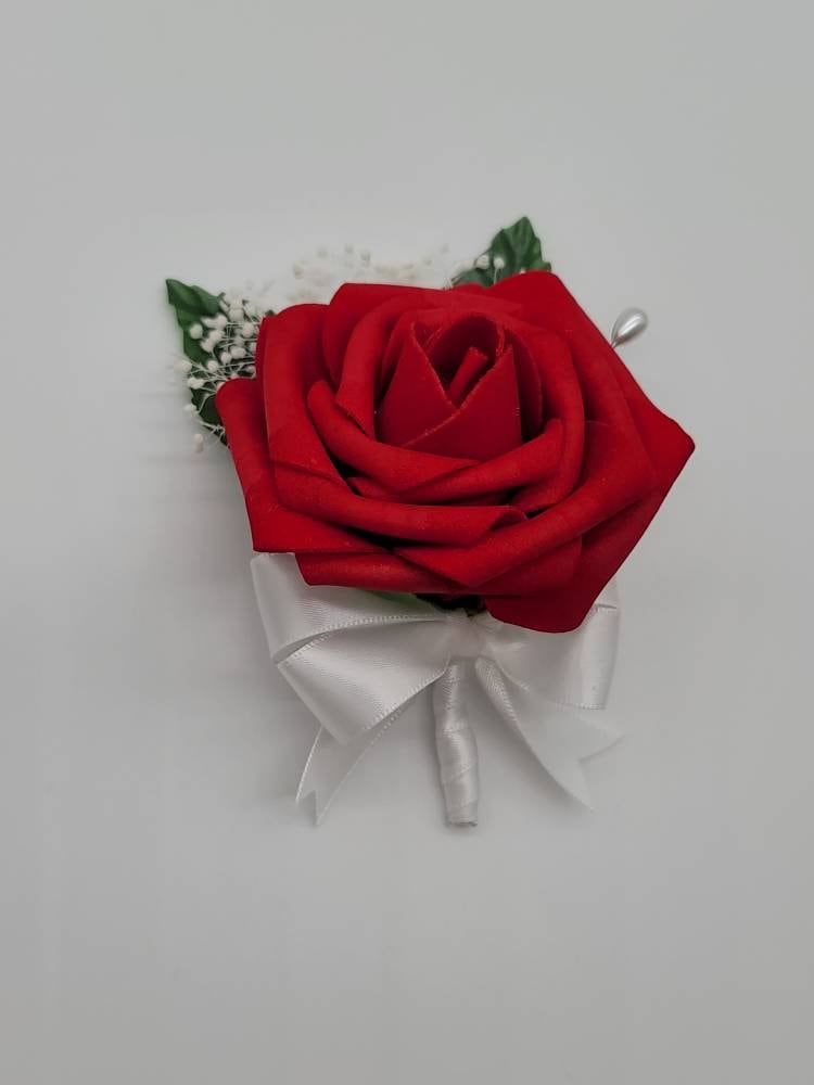 Red and white boutonniere with baby's breath and pearl pin