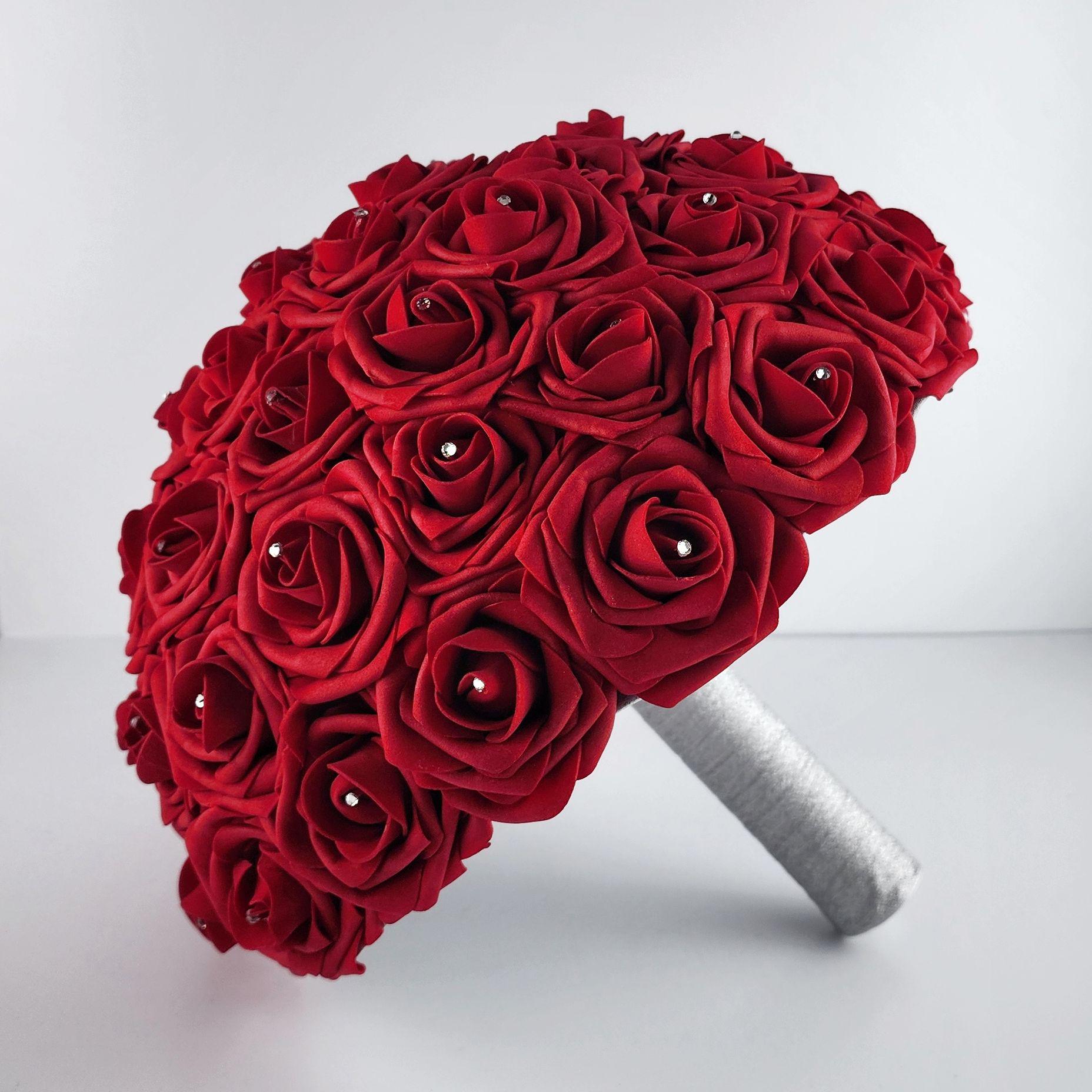 Red rose bridal bouquet with silver handle and silver brooch. Rhinestones on every rose.