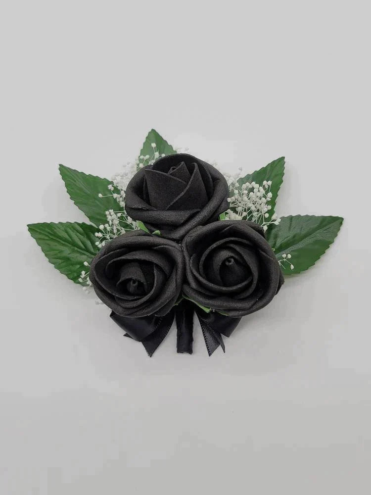 all black pin on corsage with babies breath
