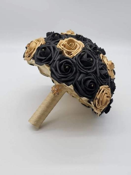 black and gold bridal bouquet in 10 inches. made from real touch roses. gold handle with gold brooch.