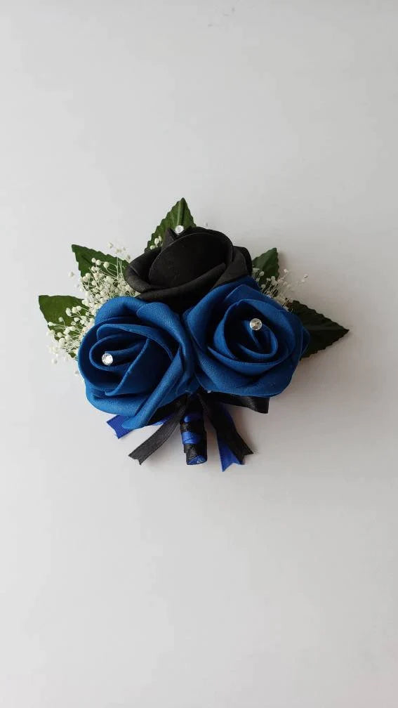 black and royal blue with french twist black and blue ribbon. Rhinestones are on every flower. Babies breath and  rose leaves