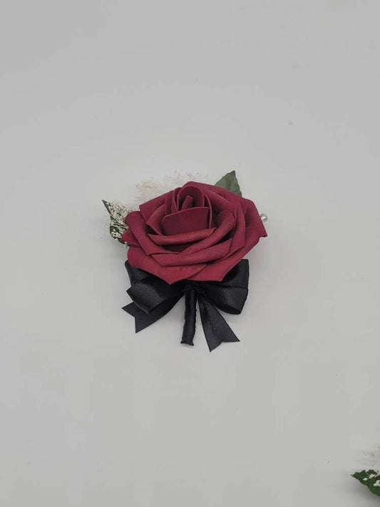 burgundy and black boutonniere with babies breath