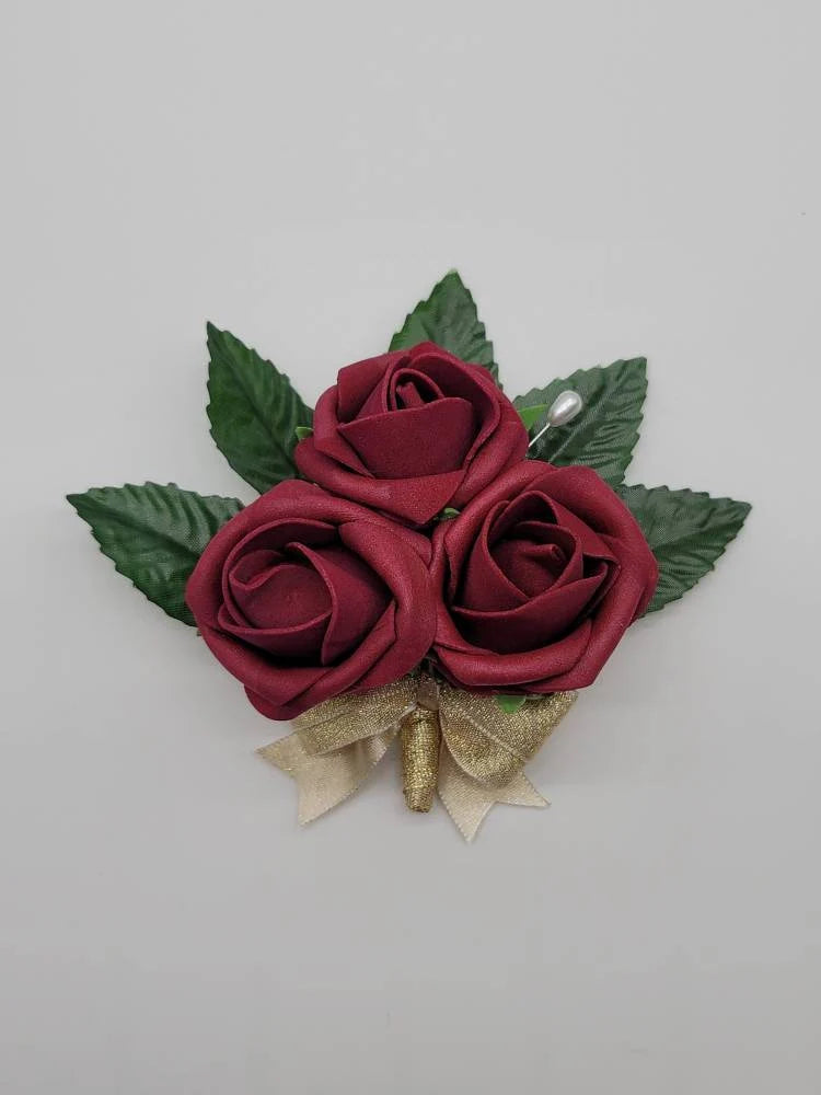 burgundy and gold pin on  corsage 