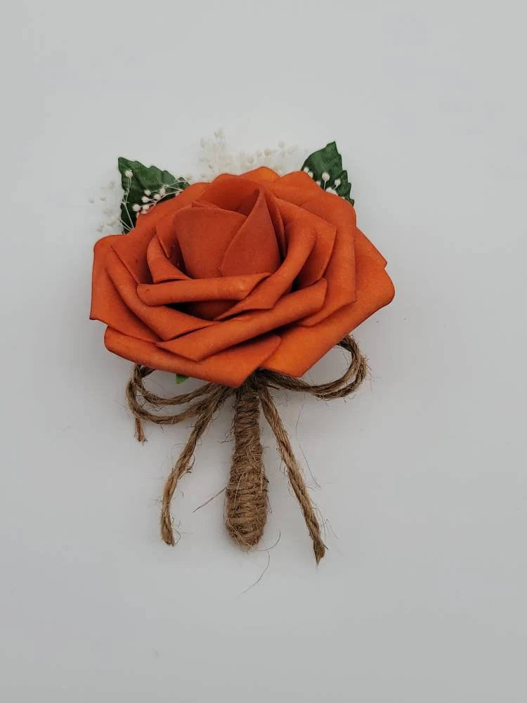 burnt orange and twine boutonniere with babies breath