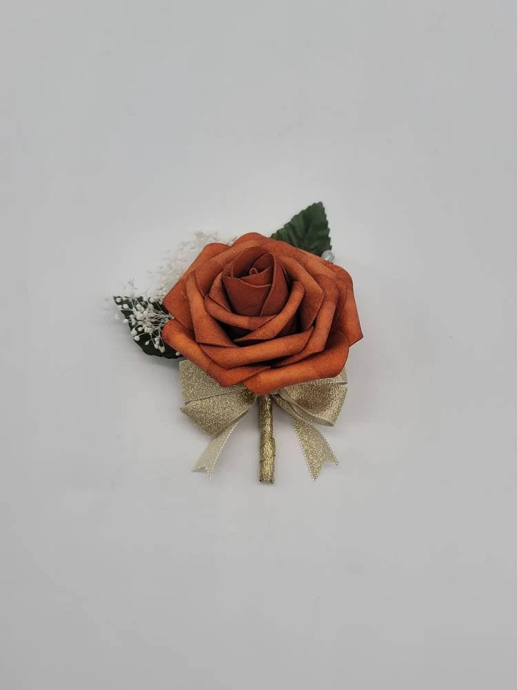 burnt orange and gold boutonnier with babies breath