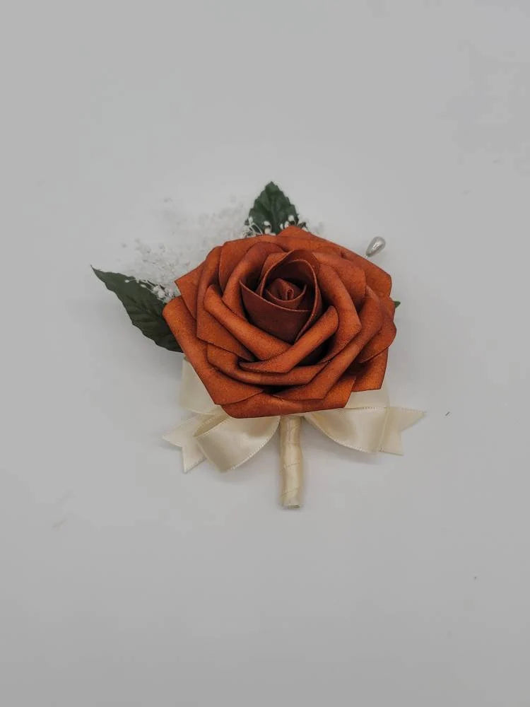 burnt orange and ivory boutonniere with babies breath