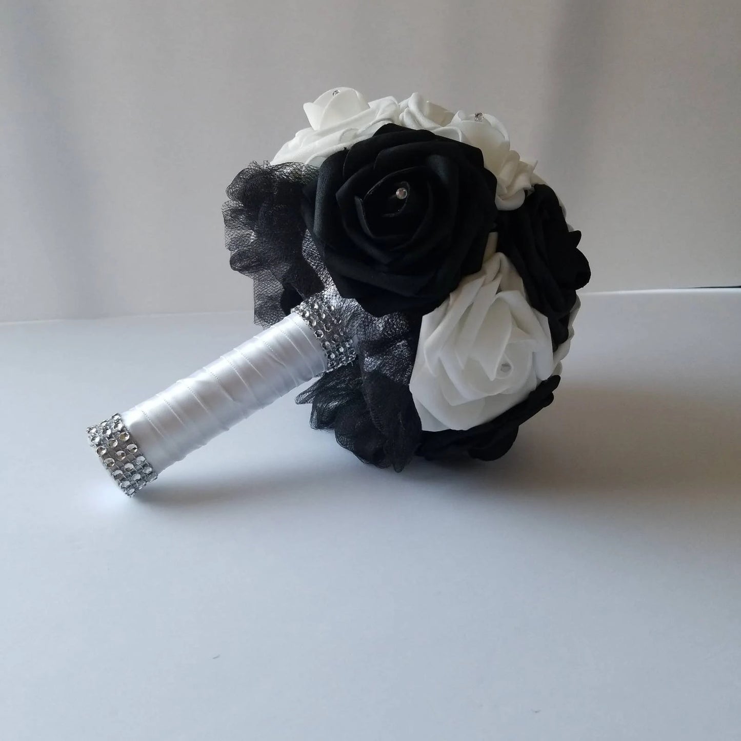 Black and white bridal bouquet with black tulle and white handle.