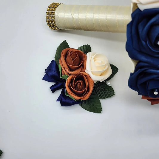 cream and burnt orange pin on corsage with navy ribbon