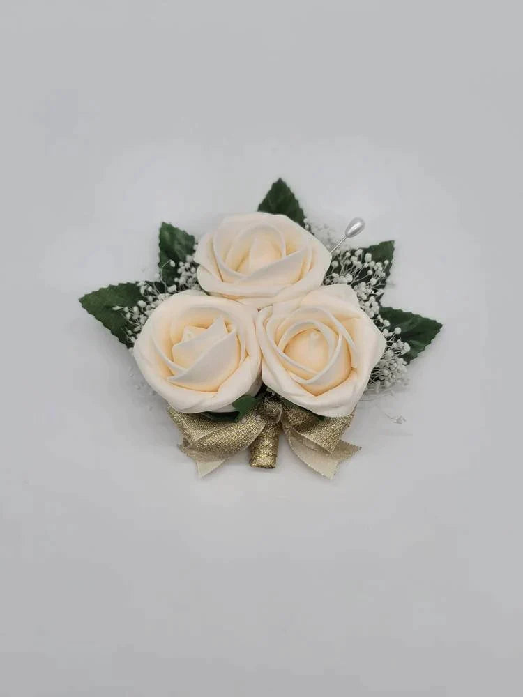 cream and gold pin on corsage with babies breatjh