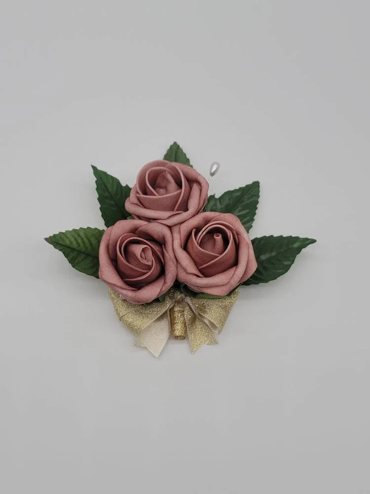 dusty rose and gold pin on corsage