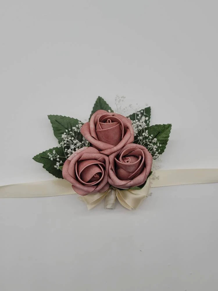 dusty rose and ivory wrist corsage with babies breath