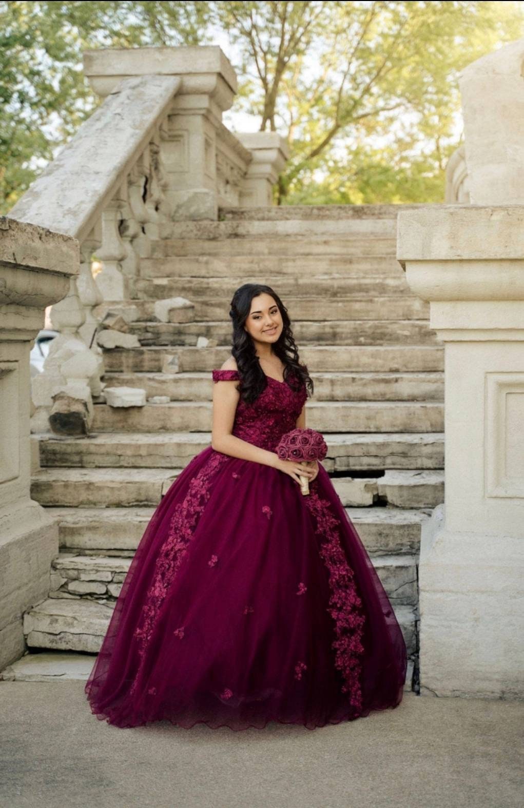 Quinceanera girl standing holding her bouquet