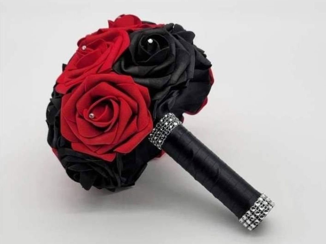 Red and black roses with satin black ribbon. Finished with silver bling wrap. Rhinestones are on every rose.