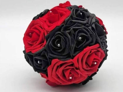 Front view of the bouquet red and black roses in a round bouquet shape. Rhinestones are in the center of every rose.