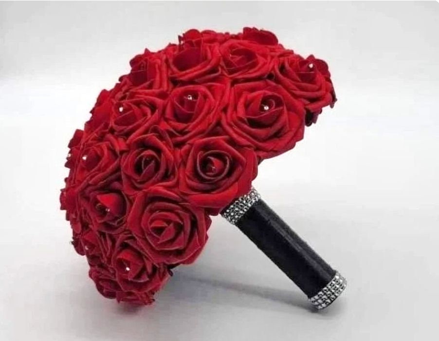 Red rose bridal bouquet made with real touch roses. Rhinestones are in the center of every rose. Handle is made up of black satin ribbon and finished with silver bling wrap. 