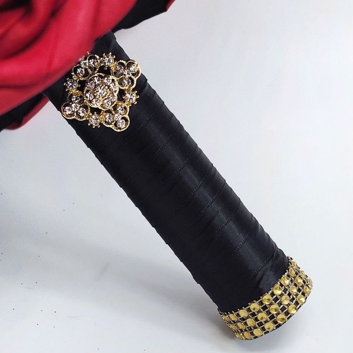 Bouquet handle-Black satin ribbon. Finished with a gold brooch and gold bling wrap.