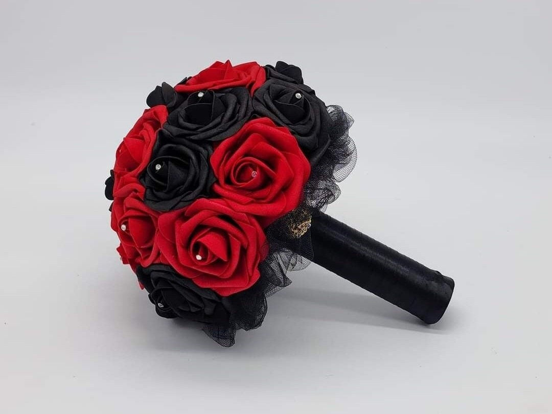 Red And Black Wedding Bouquet Made With Real Touch Roses. Rhinestones are in the center of every rose. Handle is made up of black satin ribbon and finished with a gold brooch. 