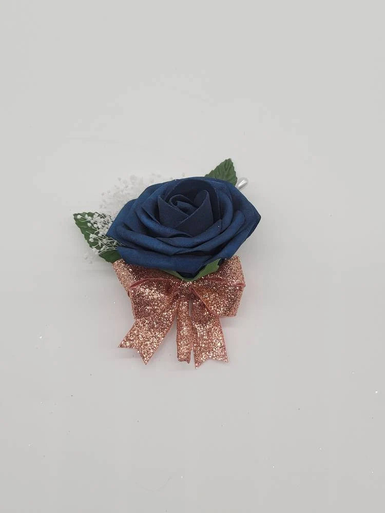 navy and rose gold boutonniere with babies breath