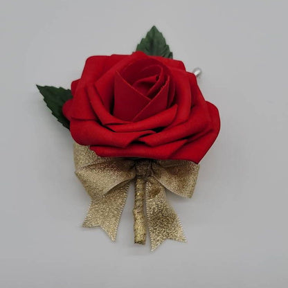 Red rose boutonniere with gold ribbon and pearl pin