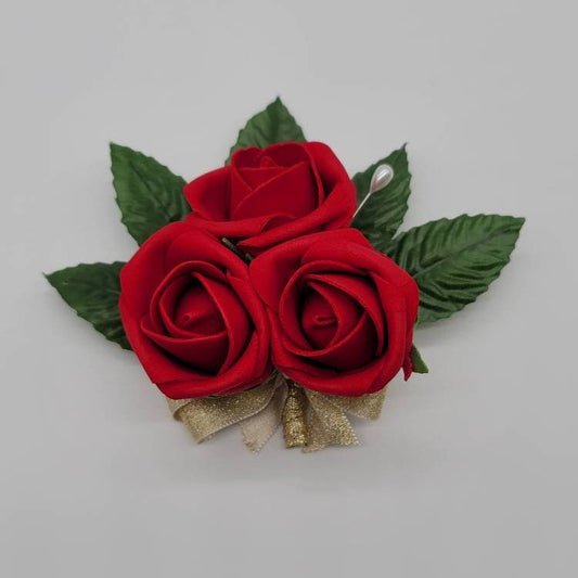 red rose pin on corsage with faux leaves and gold ribbon. Made with real touch roses