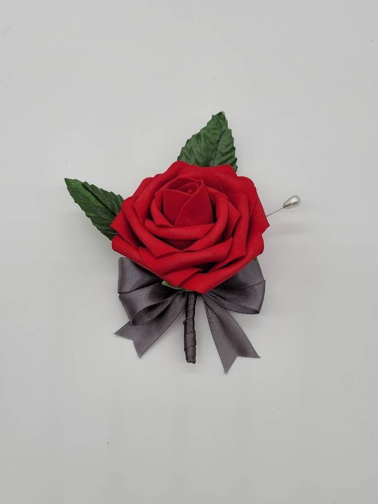 Red and Gray boutonniere. red rose with gray ribbon tied in a bow with pearl pin
