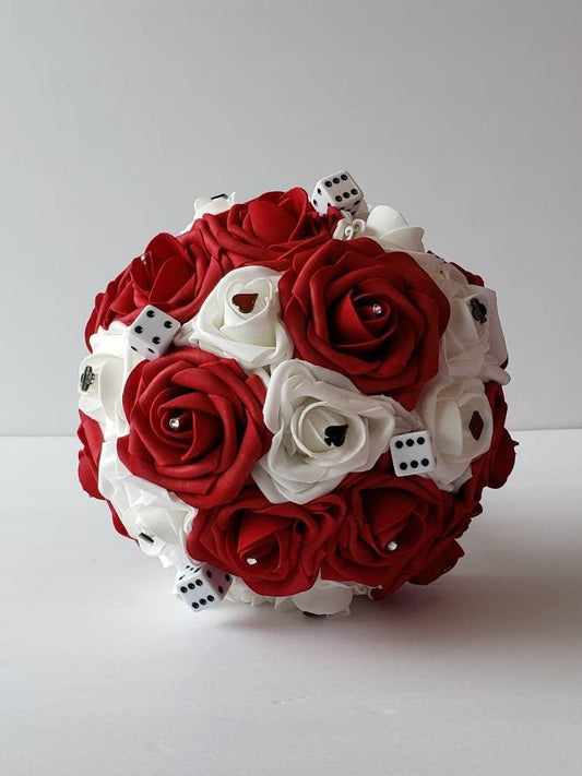 Red and white las vegas bridal bouquet made with Real touch Roses. Rhinestones, card suits, and dice scattered throughout bouquet. 