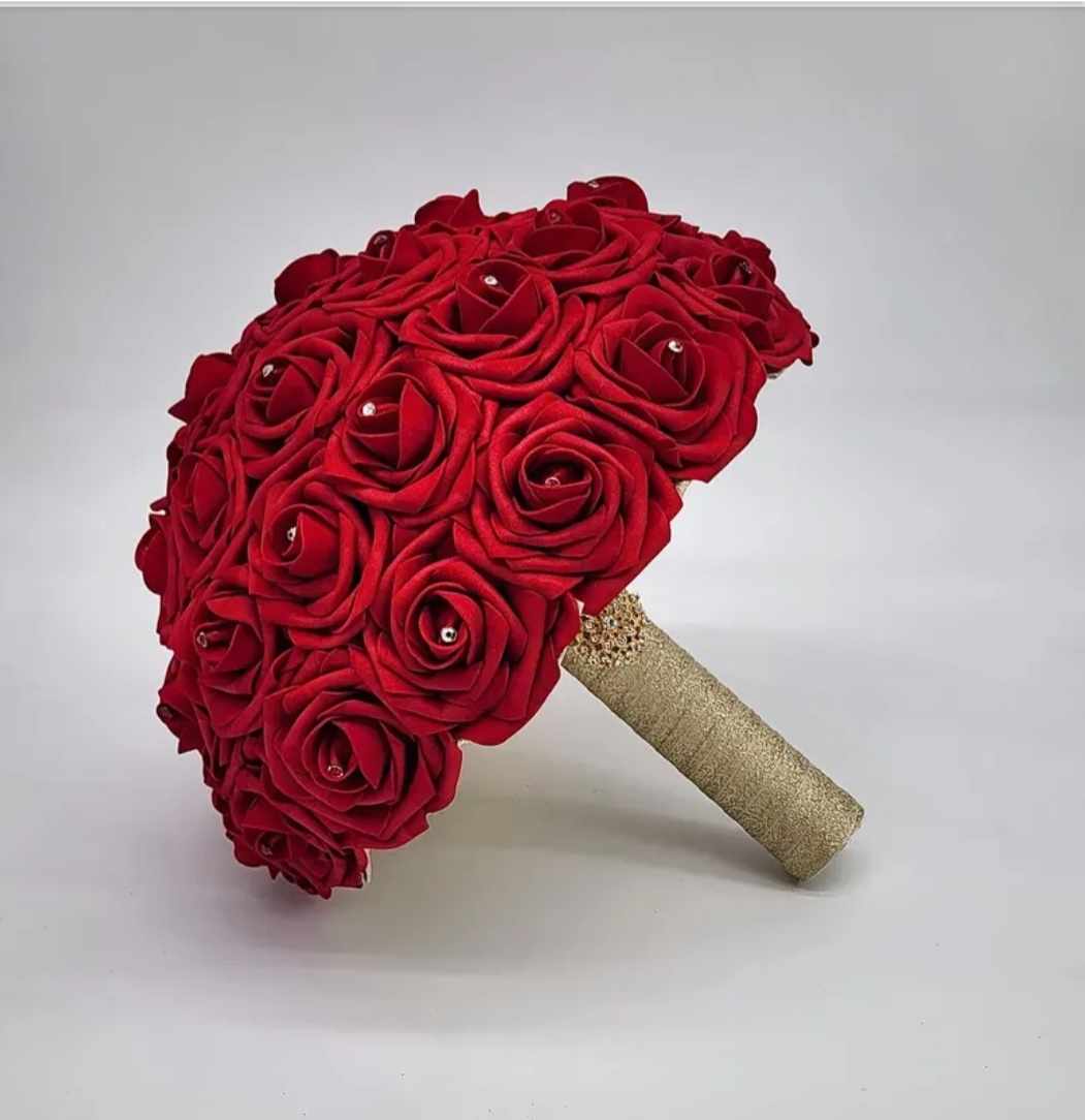  Red real touch rose bridal bouquet with rhinestone on each rose. Handle is made up of gold ribbon and finished with a gold brooch. 