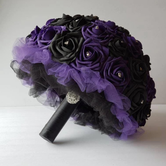 purple and black gothic bridal bouquet with black and purple tulle and black ribbon. silver skulls and silver brooch