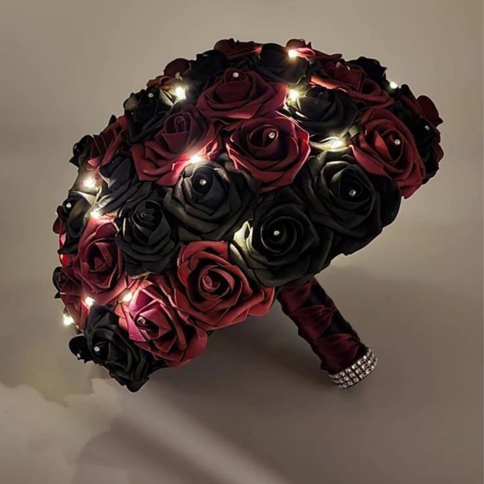burgundy and black bridal bouquet with fairy lights with a black and burgundy french twist ribbon