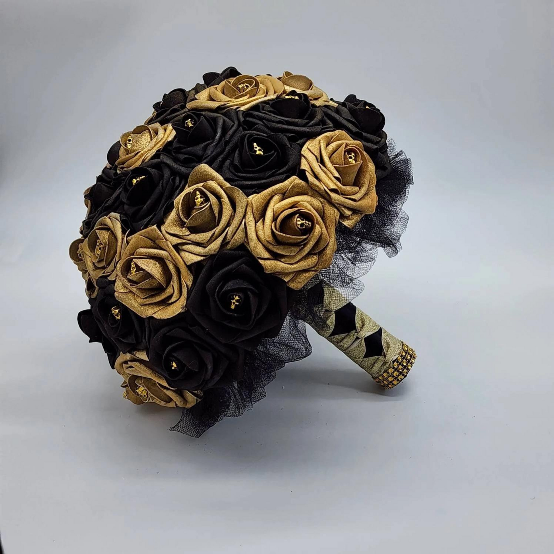 gold and black skull bouquet with french twist black and gold handle