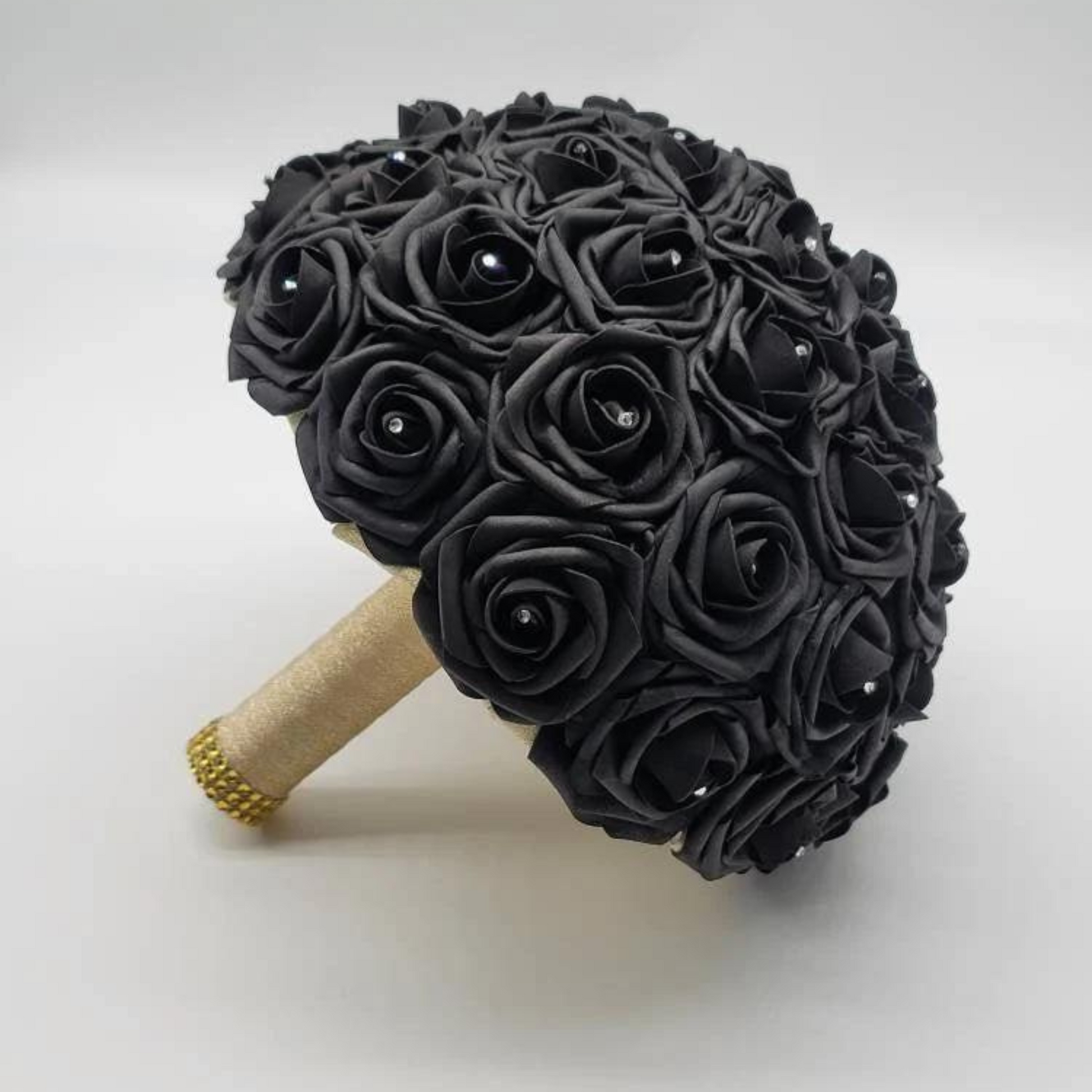 black bridal bouquet made with real touch roses and gold ribbon handle. gold bling wrap handle