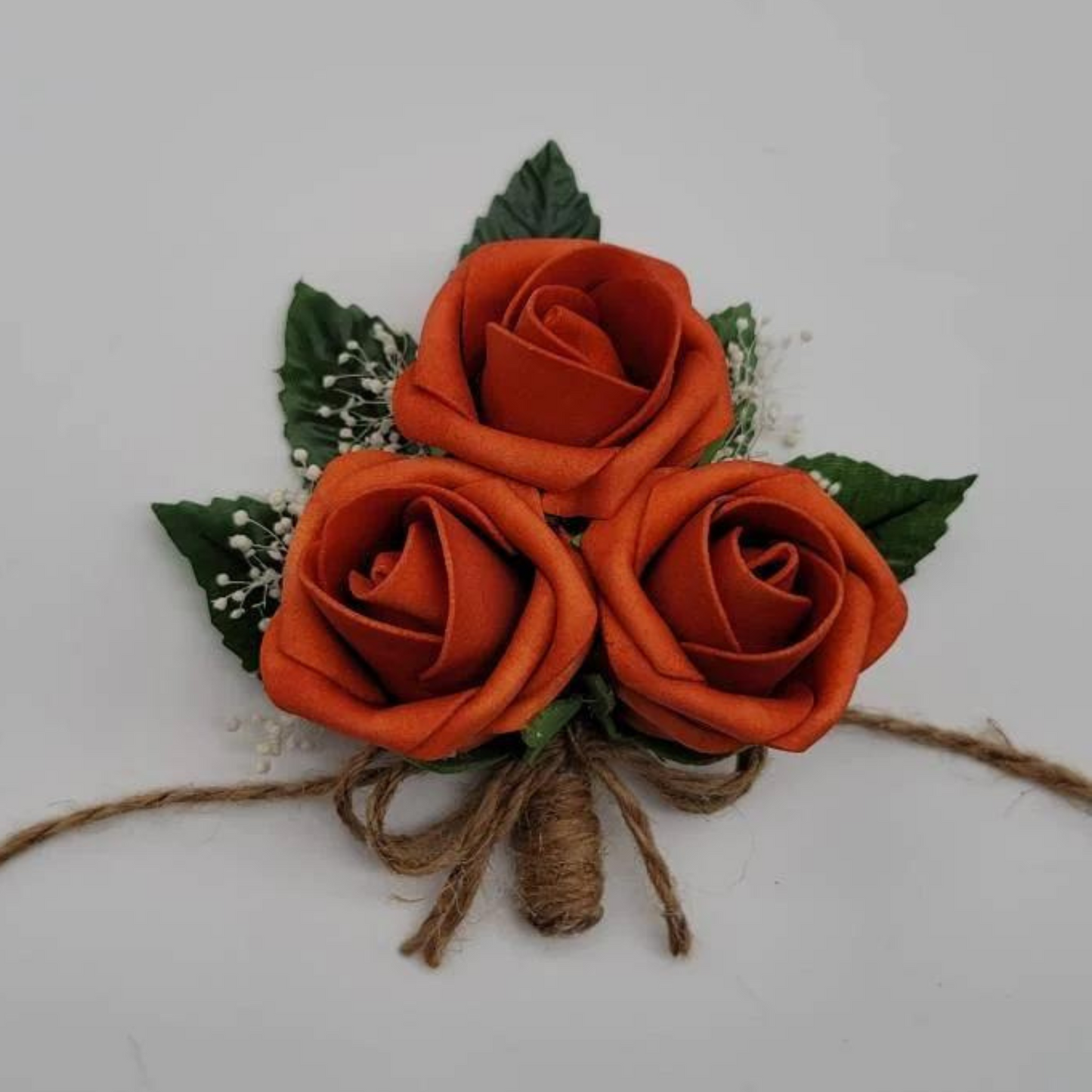 burnt orange and twine corsage with babies breath