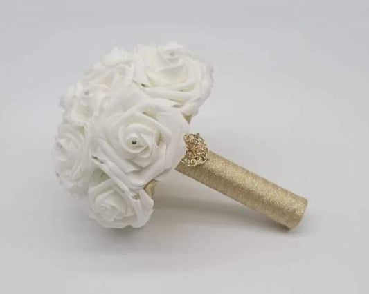 white and gold bridal bouquet made with real touch roses. Handle is made up of gold ribbon and gold brooch. 